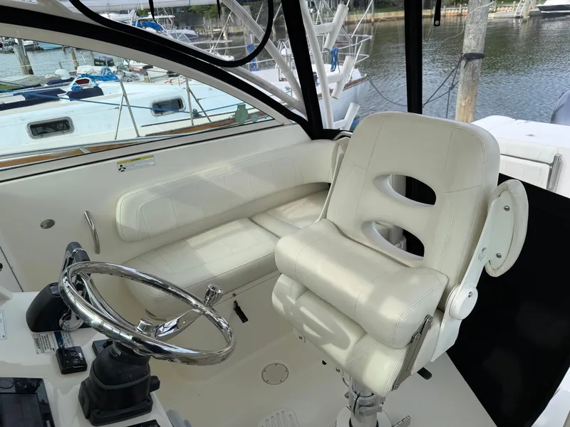 Slide: The Image of Interior of a 2016 World Cat 320 EC with white seating. - 23