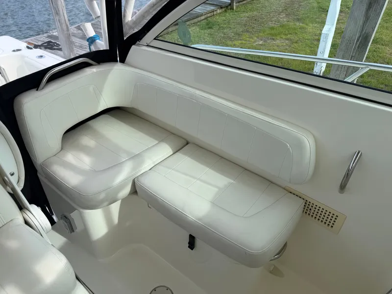 Slide: The Image of Interior of 2016 World Cat 320 EC with white seating area. - 26