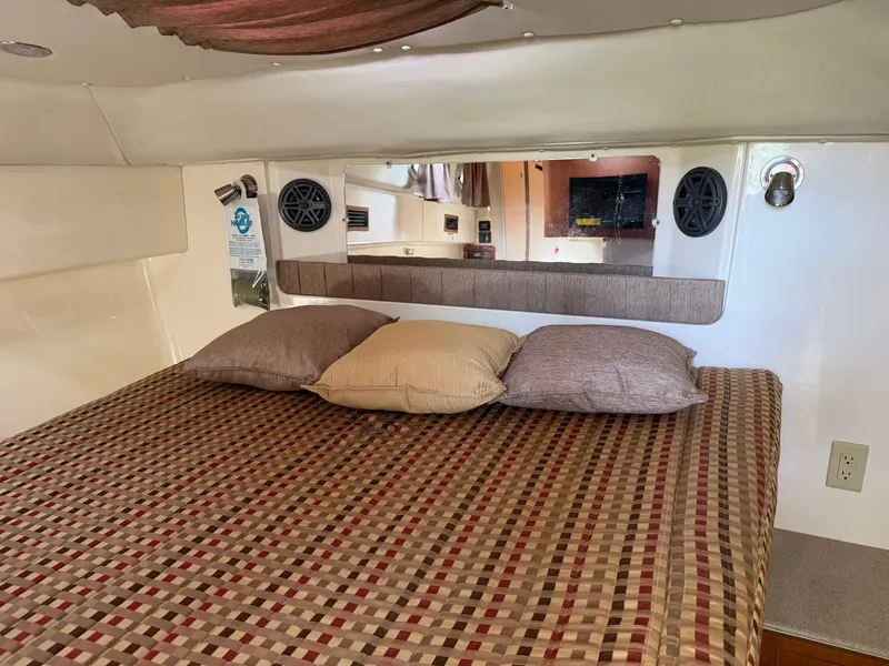 Slide: The Image of Interior of a 2016 World Cat 320 EC with bed and pillows. - 28