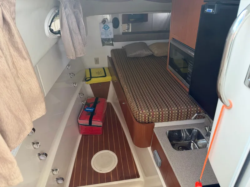 Slide: The Image of Interior of a 2016 World Cat 320 EC with bed and kitchenette. - 33