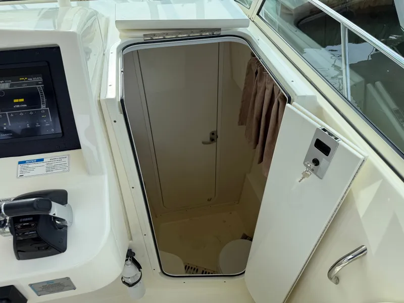 Slide: The Image of Interior of 2016 World Cat 320 EC with helm console and cabin door. - 35