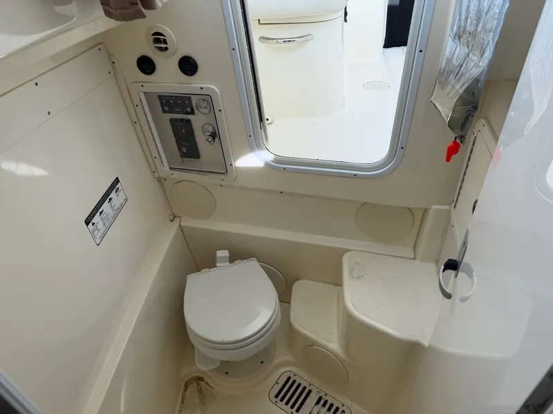 Slide: The Image of Interior of a 2016 World Cat 320 EC with toilet and controls. - 36