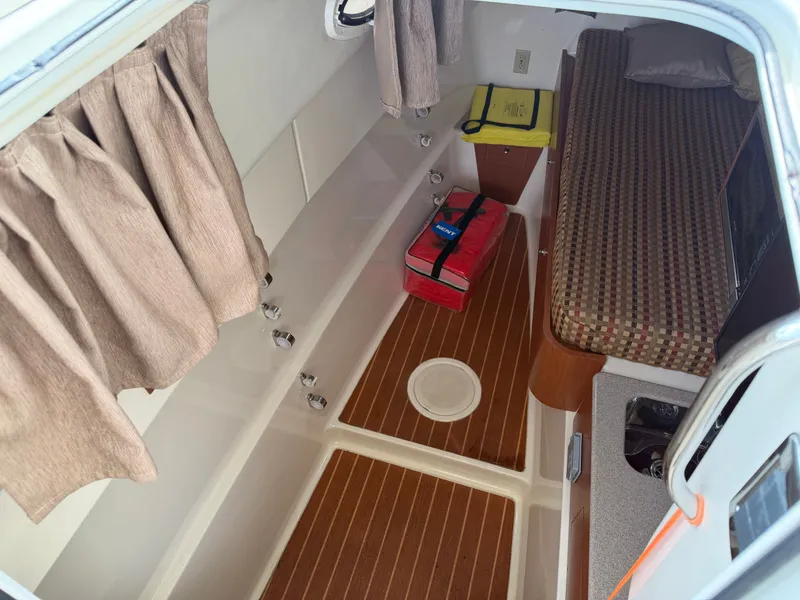Slide: The Image of Interior of 2016 World Cat 320 EC with seating and curtains. - 37