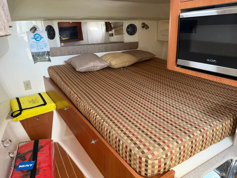 Slide: The Image of Interior of a 2016 World Cat 320 EC with bed and microwave. - 38