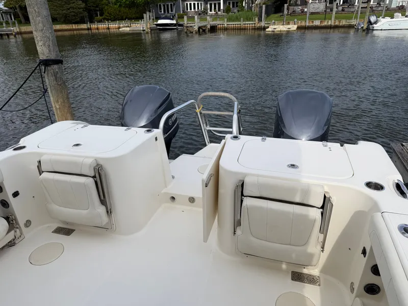 Slide: The Image of 2016 World Cat 320 EC boat stern with engines at dock. - 5