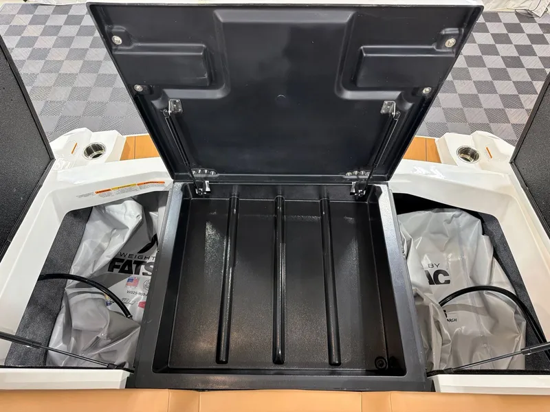 Slide: The Image of Axis A245 2026 boat storage compartment with open lid and ballast bags. - 26