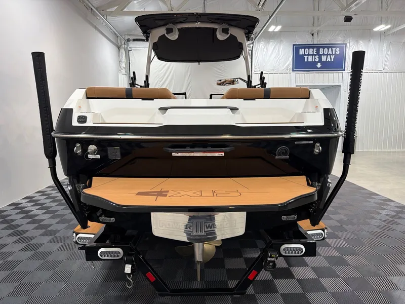 Slide: The Image of Rear view of Axis A245 boat, 2026 model, in a showroom. - 4