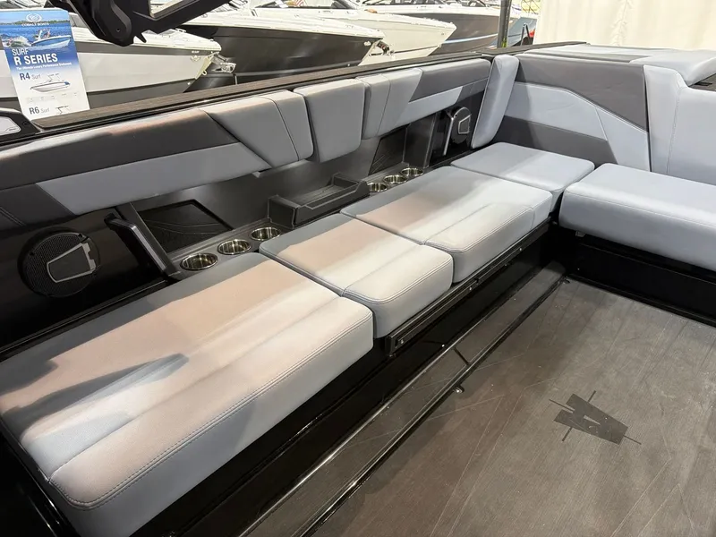 Slide: The Image of Interior of Axis T250 boat, gray upholstery, cup holders, speakers, model year 2026. - 14