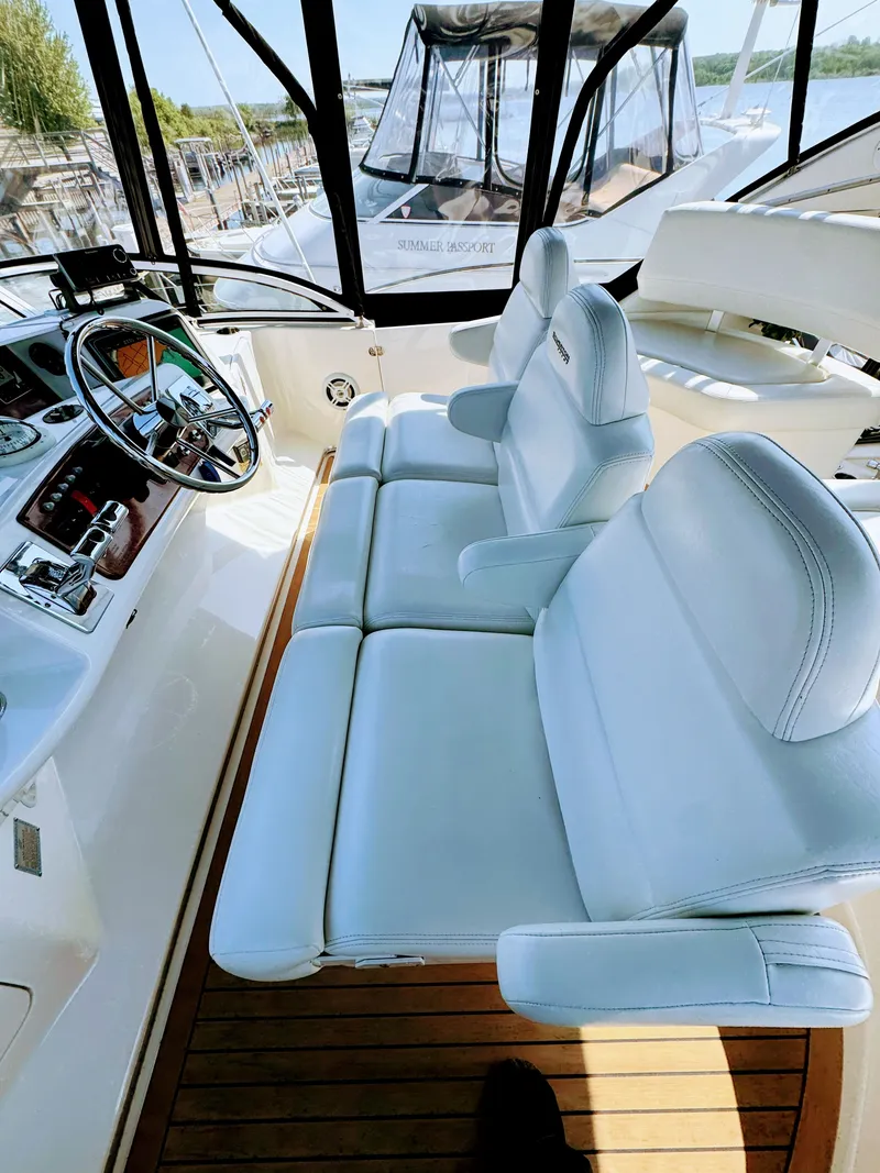 Slide: The Image of Interior of a 2002 Silverton 39 Motor Yacht with white seating. - 13