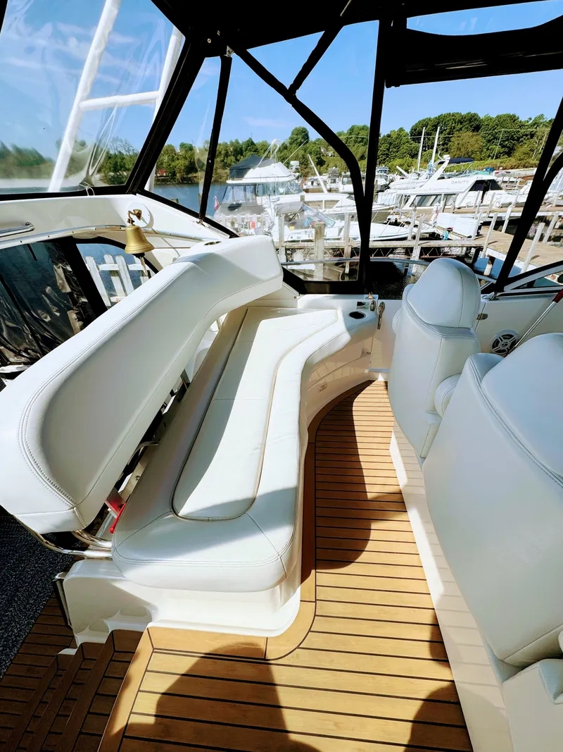 Slide: The Image of Interior of a 2002 Silverton 39 Motor Yacht with white seating. - 17