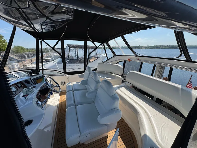 Slide: The Image of Interior of a 2002 Silverton 39 Motor Yacht with white leather seating. - 18