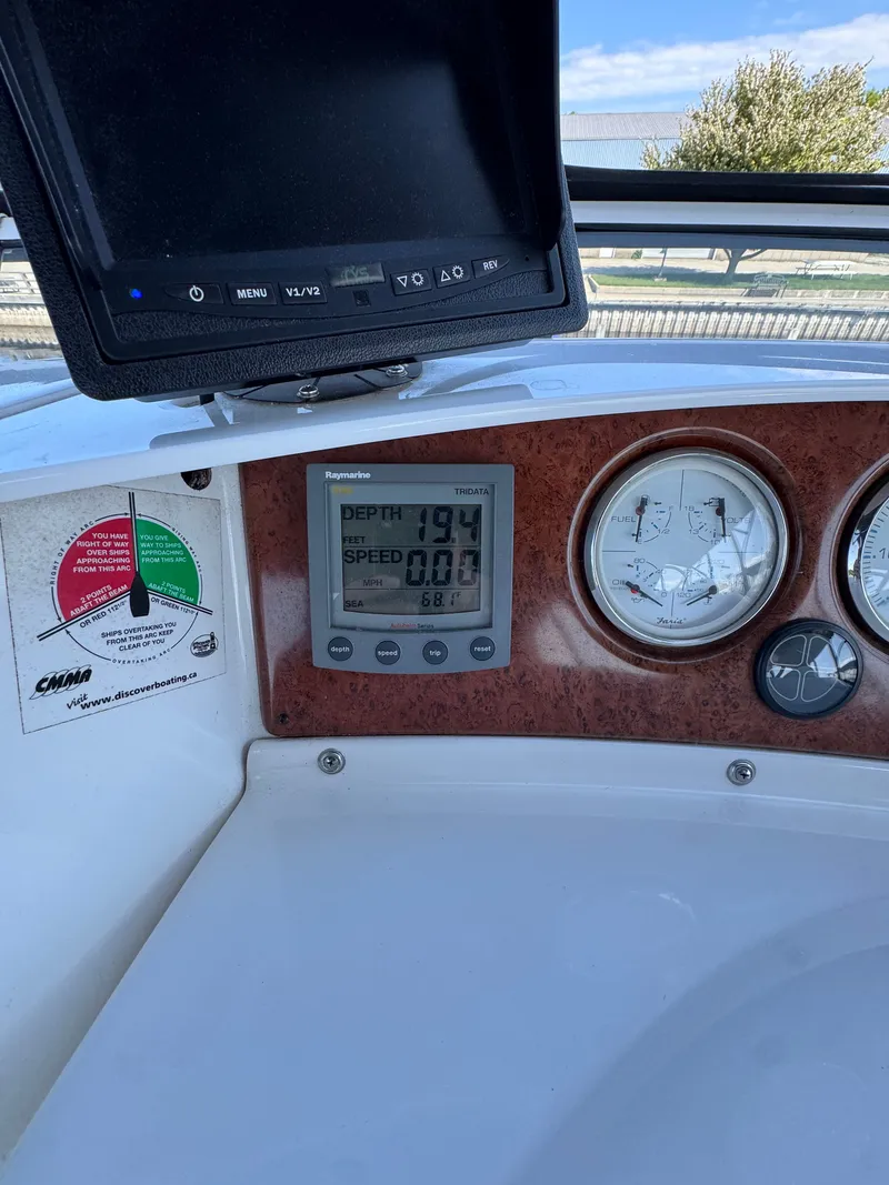 Slide: The Image of Dashboard of 2002 Silverton 39 Motor Yacht with depth gauge and monitor. - 24