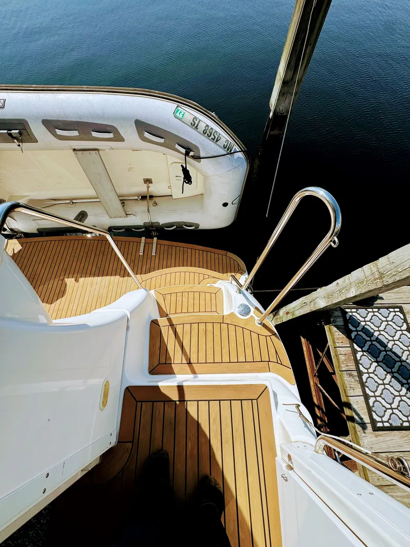 Slide: The Image of Deck of a 2002 Silverton 39 Motor Yacht with dinghy. - 34