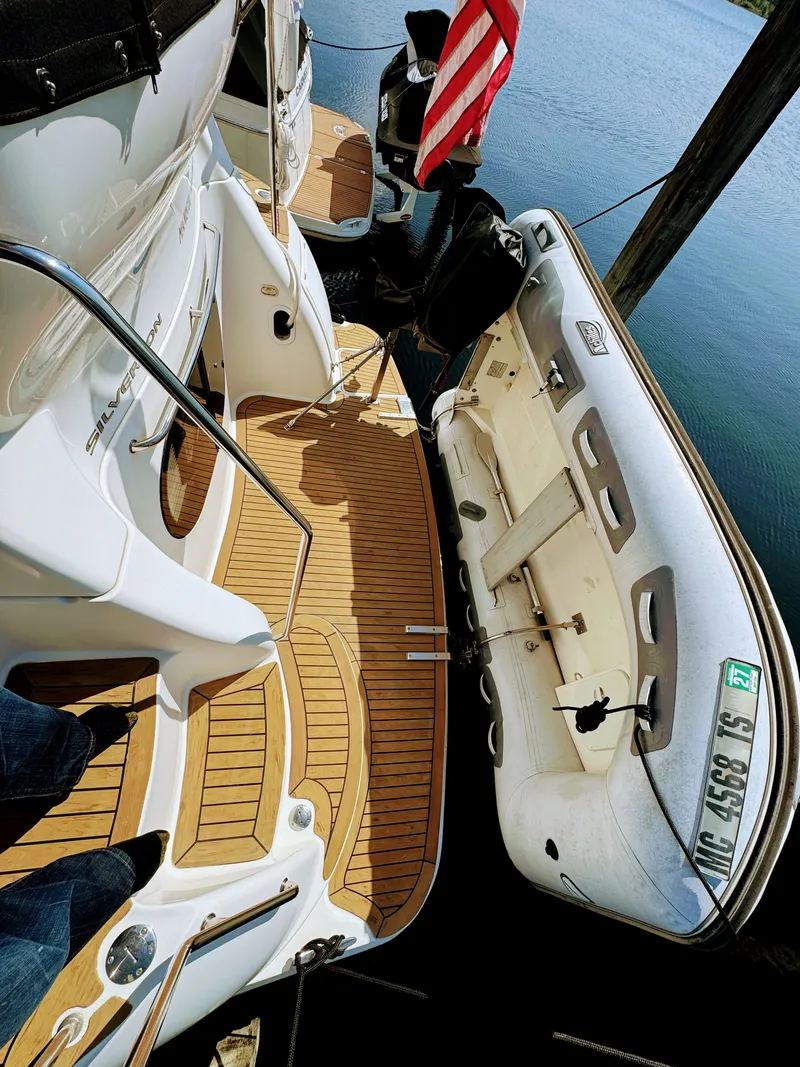 Slide: The Image of 2002 Silverton 39 Motor Yacht with dinghy at dock. - 35