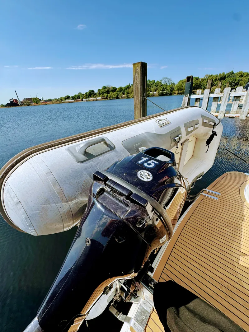 Slide: The Image of 2002 Silverton 39 Motor Yacht with dinghy at dock. - 37