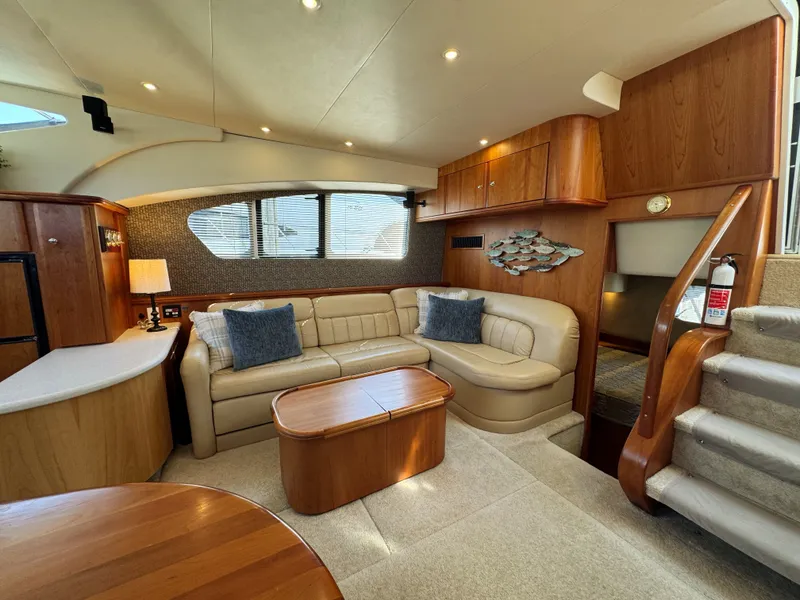 Slide: The Image of Interior of 2002 Silverton 39 Motor Yacht with leather sofa and wooden furnishings. - 41