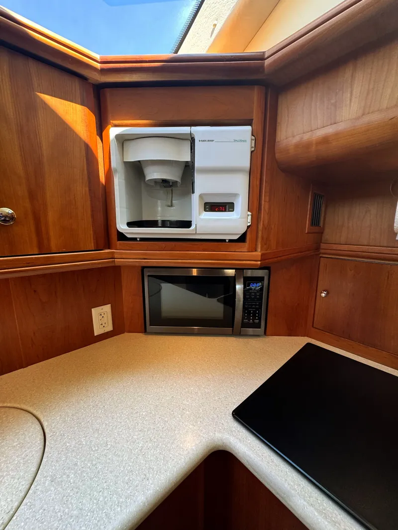 Slide: The Image of Silverton 39 Motor Yacht 2002 kitchen area with microwave and coffee maker. - 49