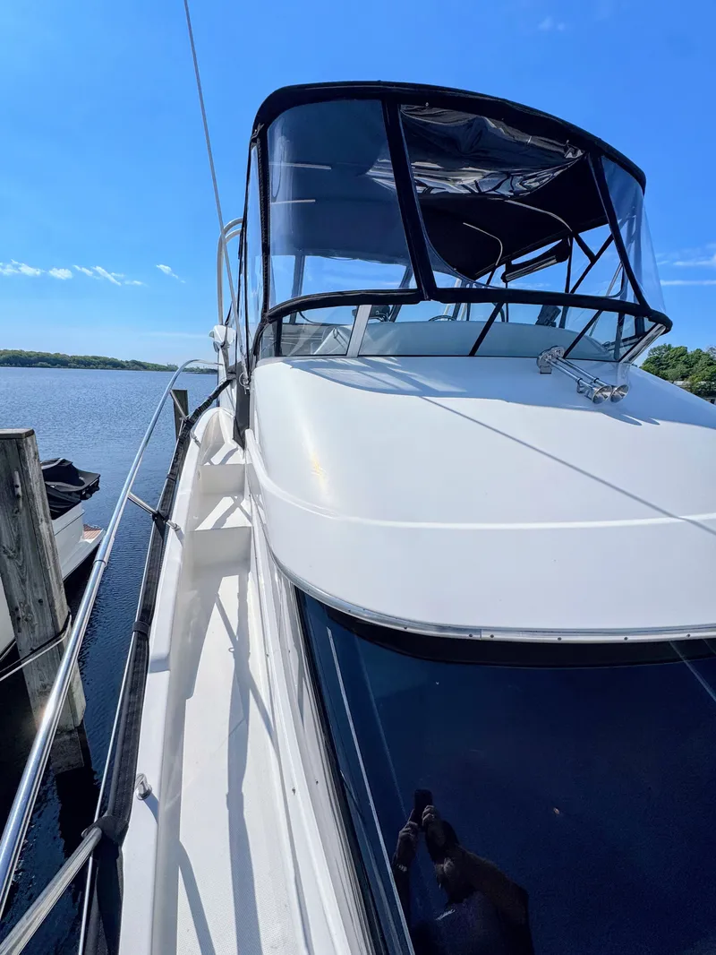 Slide: The Image of 2002 Silverton 39 Motor Yacht docked on a sunny day. - 8