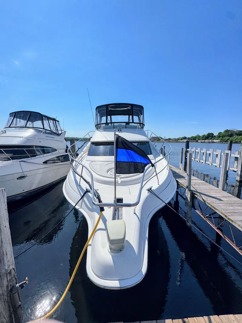 Slide: The Image of 2002 Silverton 39 Motor Yacht docked on a sunny day. - 9