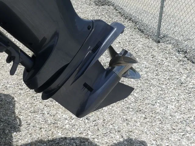 Slide: The Image of Outboard motor of a 2023 Wellcraft 222 Fisherman on gravel. - 10