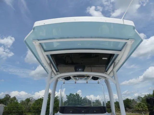 Slide: The Image of 2023 Wellcraft 222 Fisherman boat canopy under blue sky. - 14