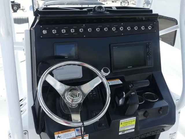 Slide: The Image of Wellcraft 222 Fisherman 2023 helm with steering wheel and controls. - 19