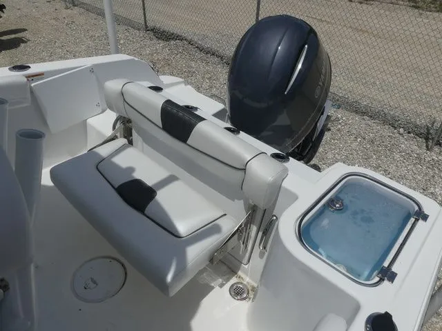 Slide: The Image of 2023 Wellcraft 222 Fisherman boat rear seating and engine view. - 21