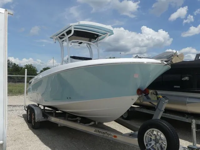 Slide: The Image of 2023 Wellcraft 222 Fisherman boat on trailer, blue sky background. - 3