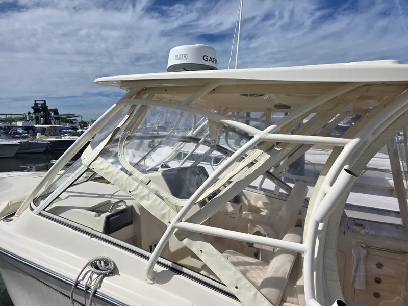 Slide: The Image of 2019 Grady-White Freedom 275 boat with clear cabin at the harbor. - 10