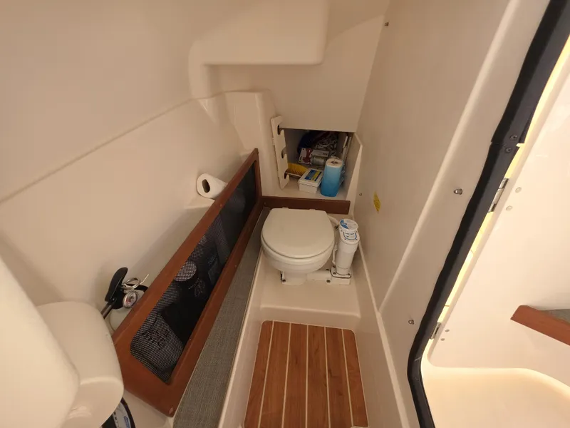 Slide: The Image of Interior of 2019 Grady-White Freedom 275 with toilet and storage area. - 17