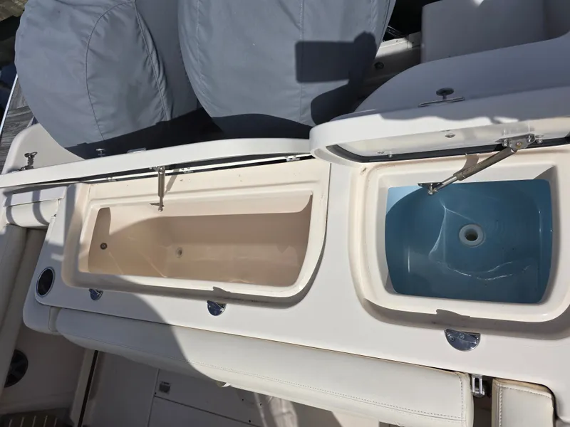 Slide: The Image of 2019 Grady-White Freedom 275 boat with two open storage compartments. - 21