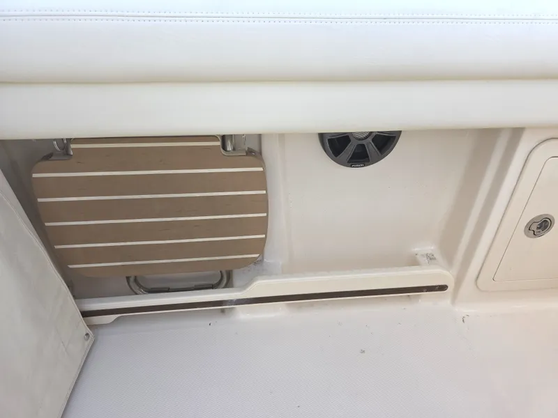 Slide: The Image of 2019 Grady-White Freedom 275 boat interior with speaker and foldable table. - 22