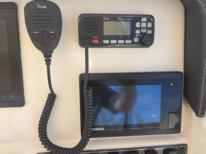 Slide: The Image of Grady-White Freedom 275 boat console with ICOM radio and Yamaha display. - 25