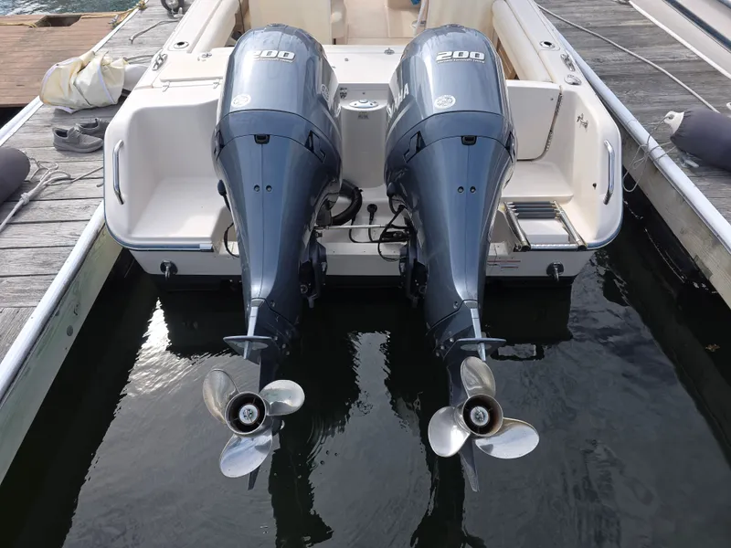 Slide: The Image of 2019 Grady-White Freedom 275 with twin outboard engines at dock. - 5