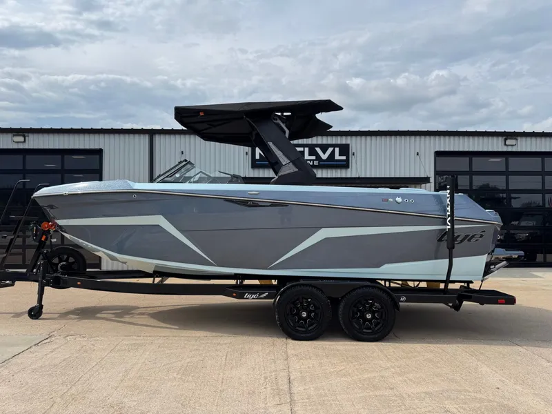 The Image of 2026 Tigé Z3 boat on trailer in front of warehouse. - 1