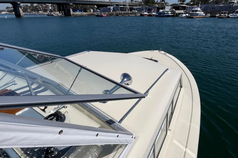 Slide: The Image of 1966 Chris-Craft 27 Commander boat on water, showcasing sleek design and clear windshield. - 10