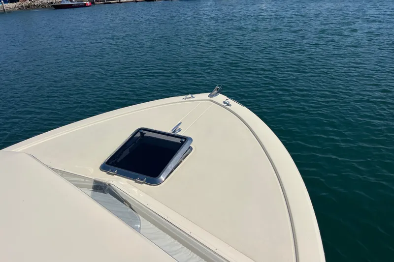 Slide: The Image of 1966 Chris-Craft 27 Commander boat bow on calm water, featuring a hatch. - 11