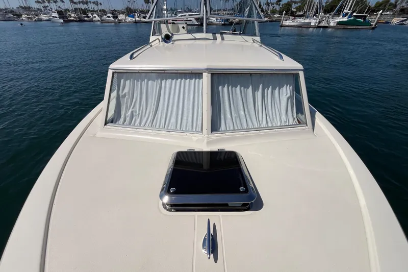 Slide: The Image of 1966 Chris-Craft 27 Commander boat on water, showcasing deck and cabin windows. - 13