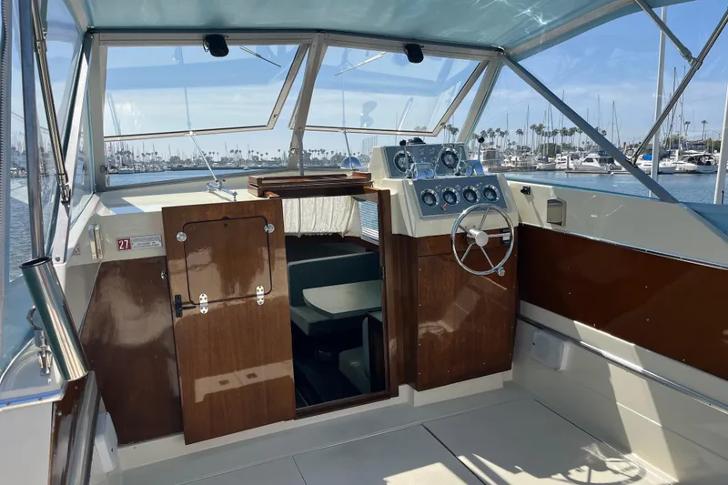 Slide: The Image of 1966 Chris-Craft 27 Commander boat interior with classic wooden dashboard and steering wheel. - 20
