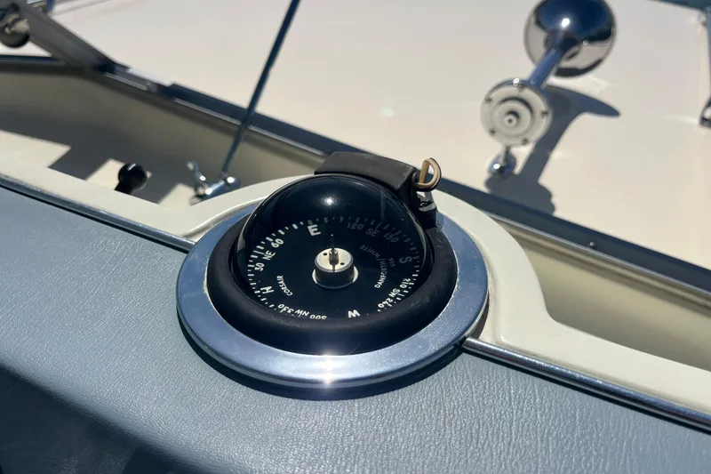 Slide: The Image of Compass on 1966 Chris-Craft 27 Commander boat dashboard in sunlight. - 29