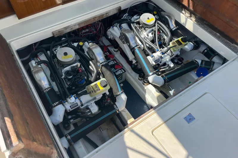 Slide: The Image of Engine compartment of a 1966 Chris-Craft 27 Commander, showcasing dual engines and mechanical components. - 30