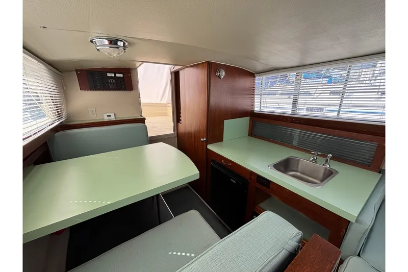 Slide: The Image of Interior of a 1966 Chris-Craft 27 Commander boat with dining area and kitchenette. - 36