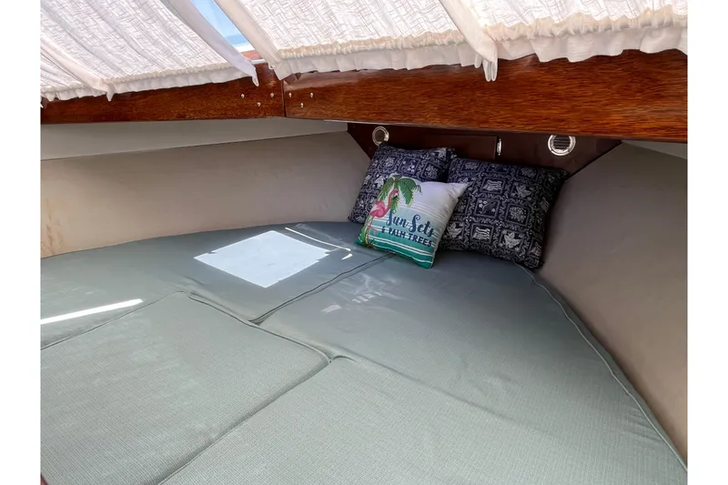 Slide: The Image of Cozy cabin interior of 1966 Chris-Craft 27 Commander with decorative pillows and soft bedding. - 40
