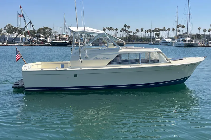 Slide: The Image of 1966 Chris-Craft 27 Commander boat docked in a marina, clear sky background. - 5