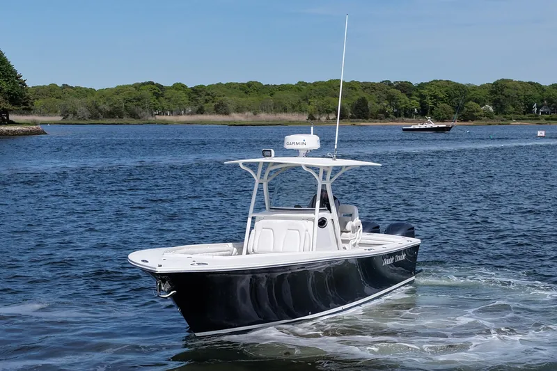 Slide: The Image of 2019 Regulator 28 Forward Seating boat cruising on a scenic lake. - 1