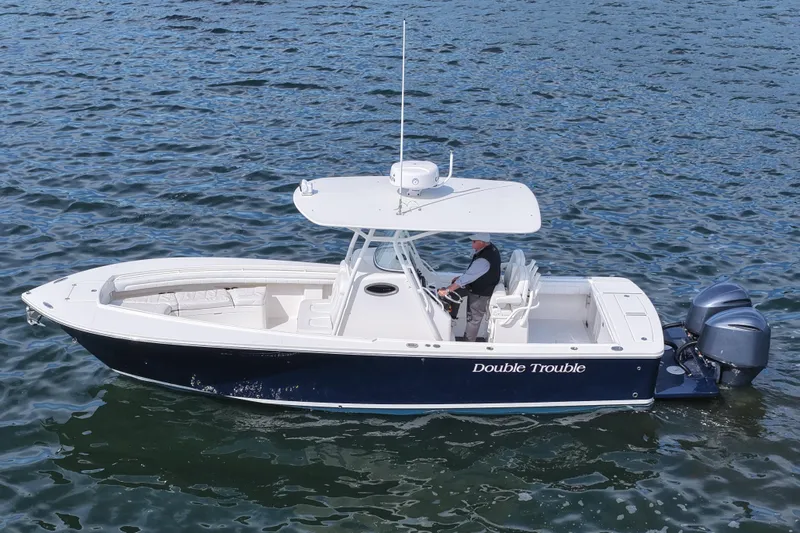 Slide: The Image of 2019 Regulator 28 Forward Seating boat on water, named "Double Trouble." - 13