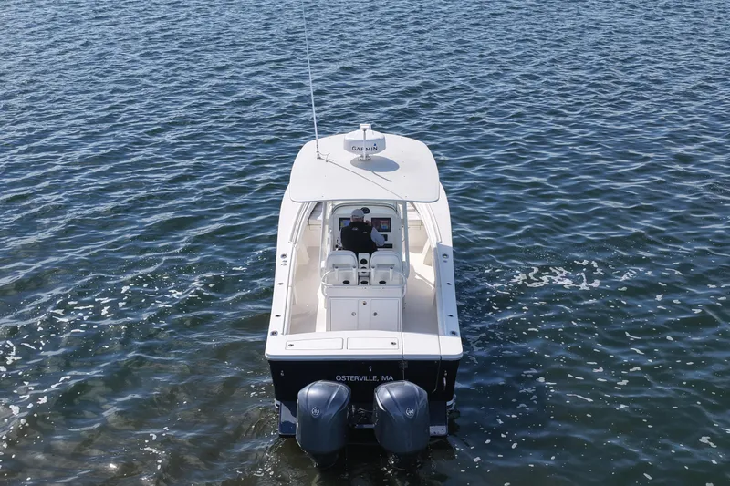 Slide: The Image of 2019 Regulator 28 Forward Seating boat on open water, rear view. - 14