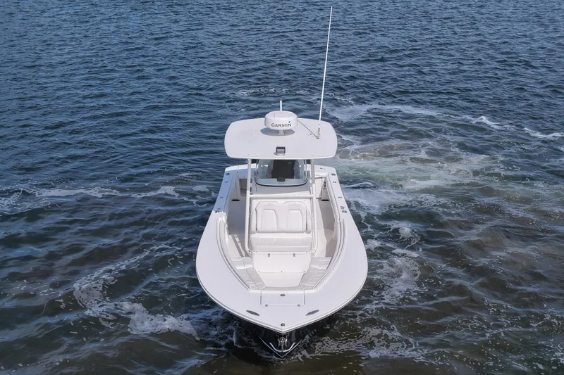 Slide: The Image of 2019 Regulator 28 Forward Seating boat on open water, aerial view. - 16