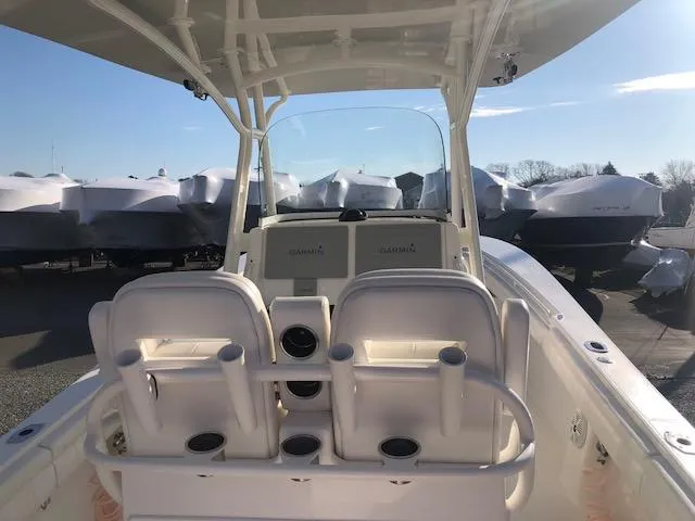 Slide: The Image of 2019 Regulator 28 Forward Seating boat with helm and seating area. - 18