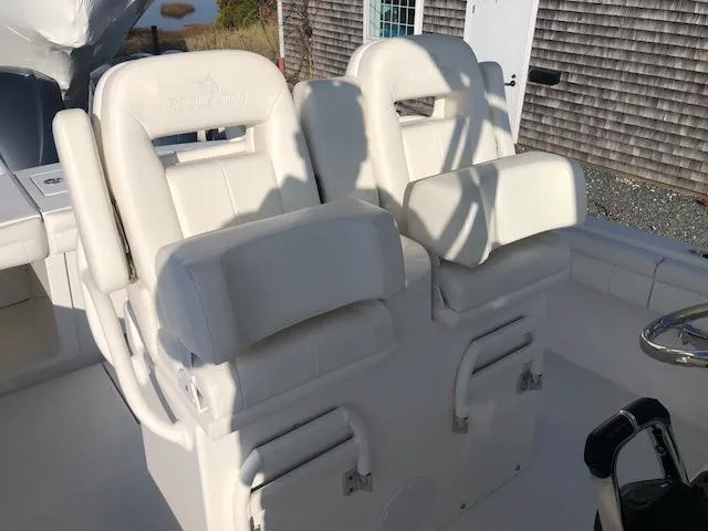 Slide: The Image of 2019 Regulator 28 boat seats, white upholstery, outdoor view. - 20
